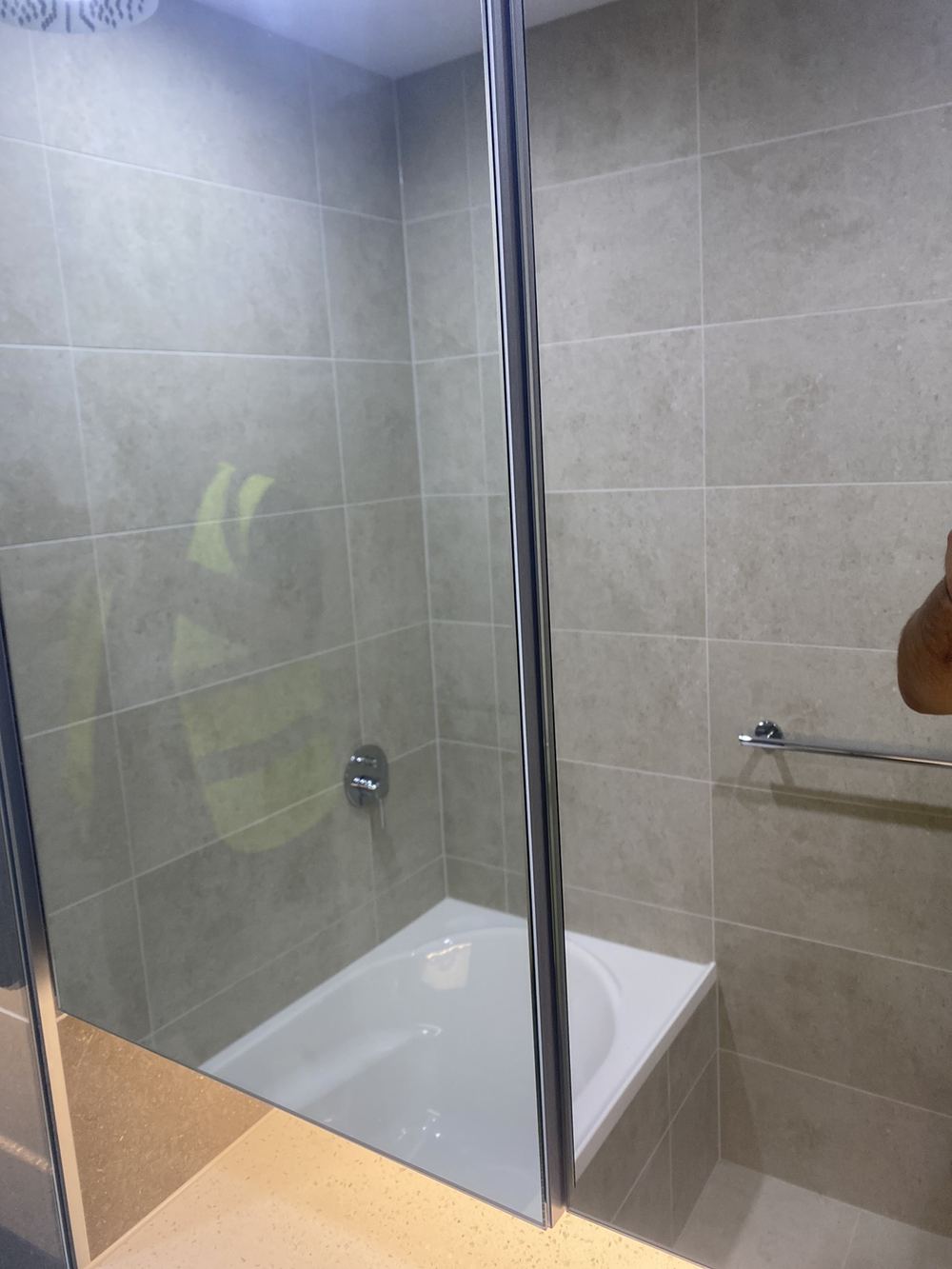 Bathroom vanity doors hung with uneven gaps between them, found during a handover inspection in Tallawong