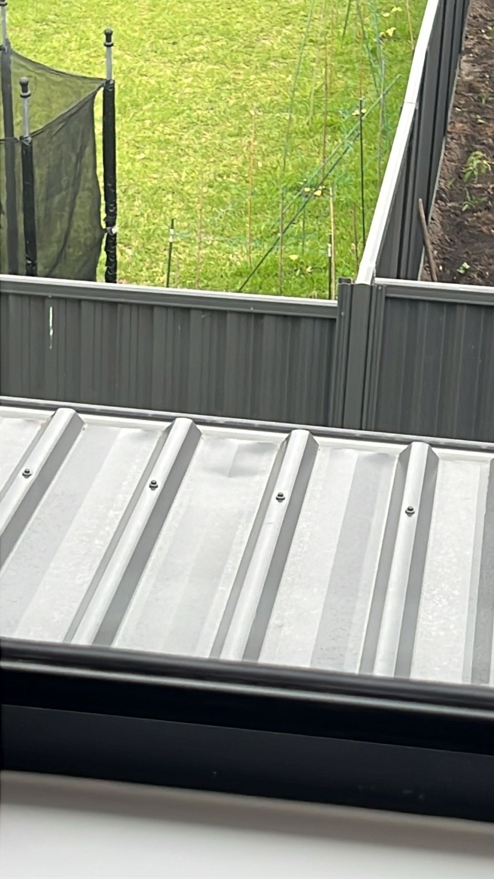 Dented and scratched metal roof sheeting with the paint coating broken, found during a handover inspection in Tallawong