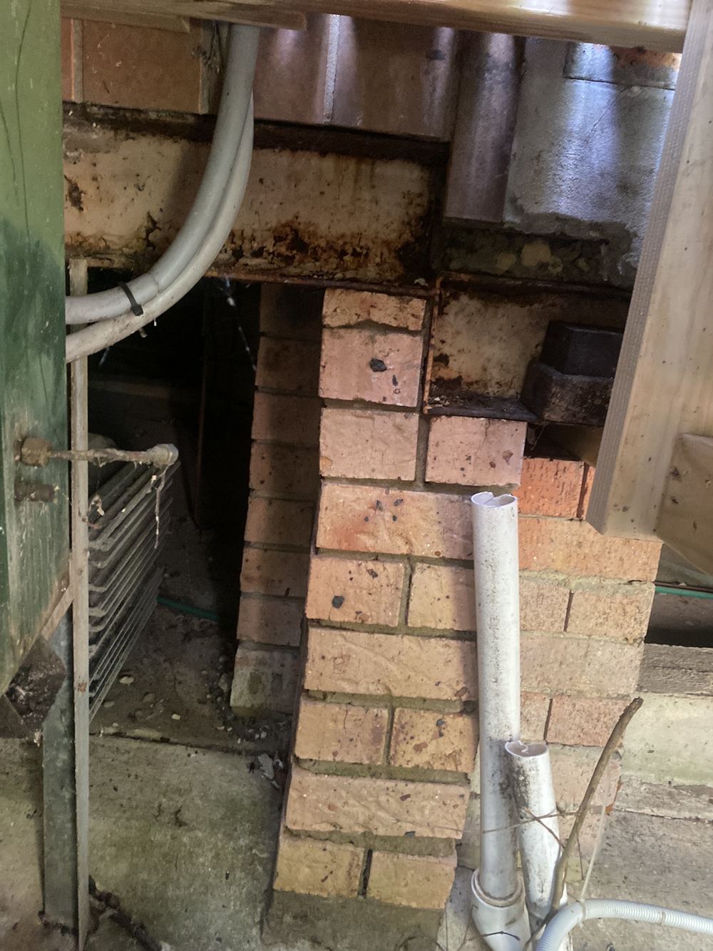 Structural steel beam rusting under run off from a loose downpipe, found during a pre-purchase inspection in St Ives